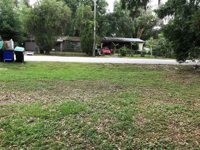 a view of park with large trees