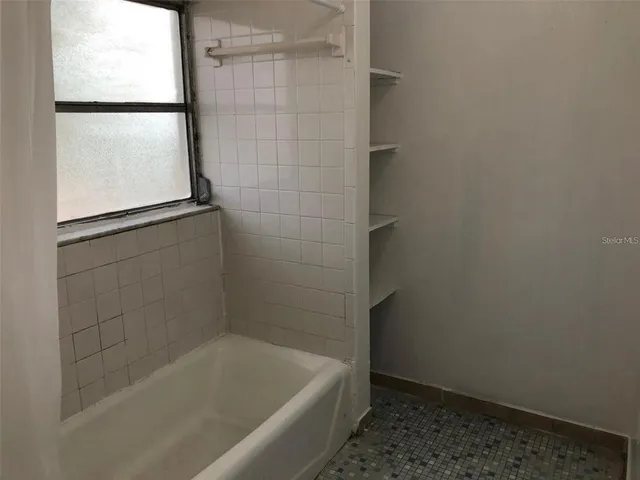a bath tub sitting next to a window