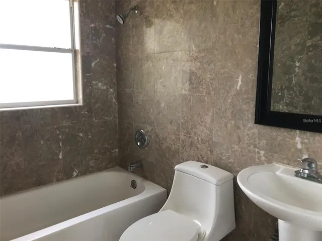 a bathroom with a sink toilet and bathtub