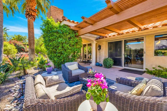 a view of a patio with couches chairs and a potted plant