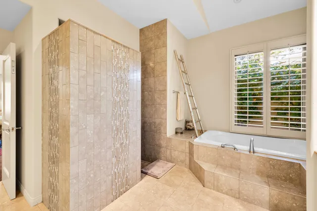 a spacious bathroom with a granite countertop tub sink and mirror