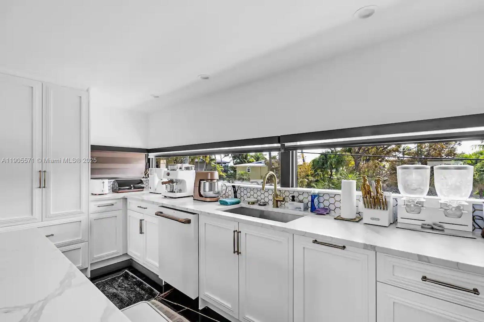32 North Bounty Lane, Unit 32 Key Largo, FL 33037 - Photo 15 of 55 a kitchen with a sink stove and cabinets