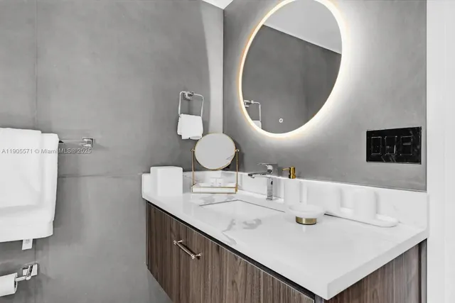 a bathroom with a sink mirror vanity and toilet