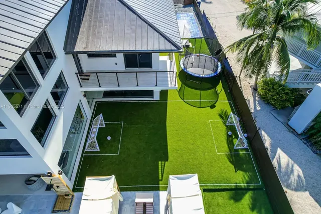 a view of a swimming pool with a patio and a yard