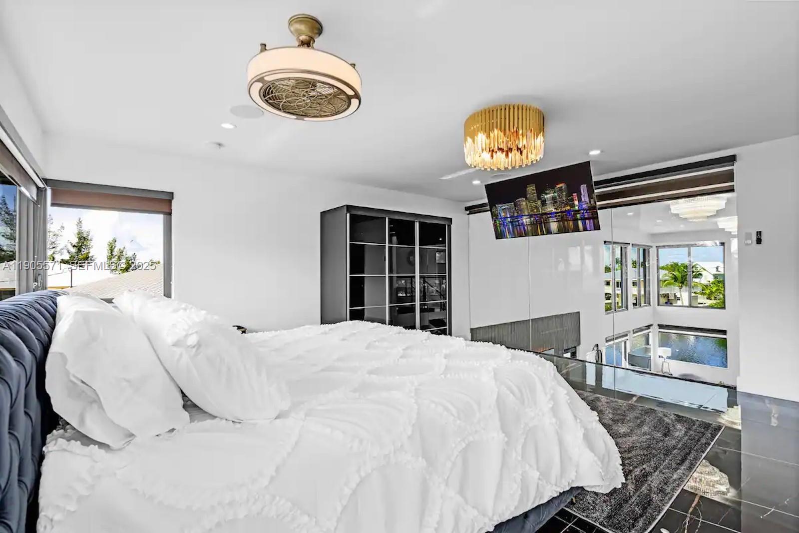 32 North Bounty Lane, Unit 32 Key Largo, FL 33037 - Photo 36 of 55 a bedroom with a bed and a chandelier