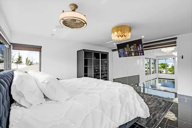 a room with gym equipment pool table and window