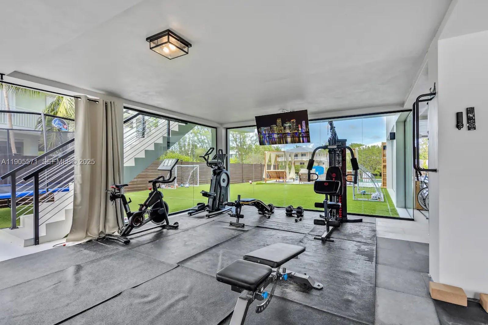 32 North Bounty Lane, Unit 32 Key Largo, FL 33037 - Photo 39 of 55 a living room with furniture a floor to ceiling window and a flat screen tv