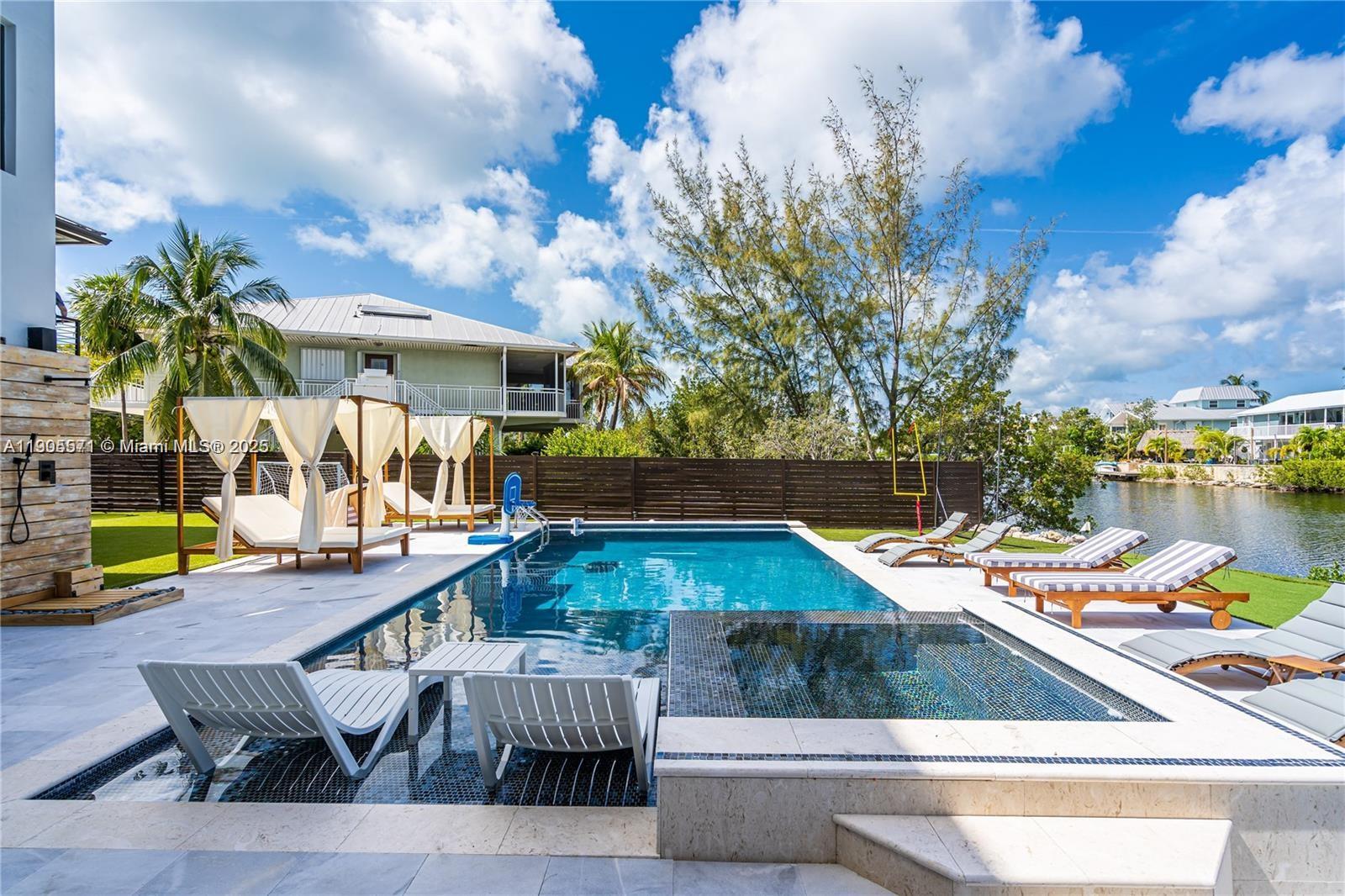 32 North Bounty Lane, Unit 32 Key Largo, FL 33037 - Photo 4 of 55 a view of a swimming pool with a patio and a yard