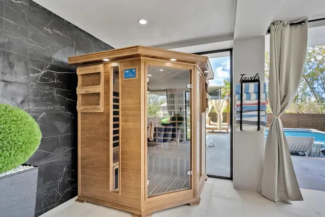 a living room with furniture gym equipment and a large window