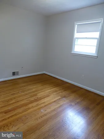 an empty room that has a window in it