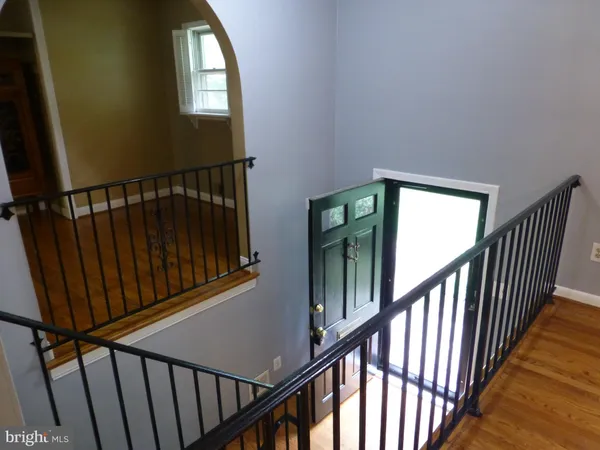 a view of staircase with railing and a window
