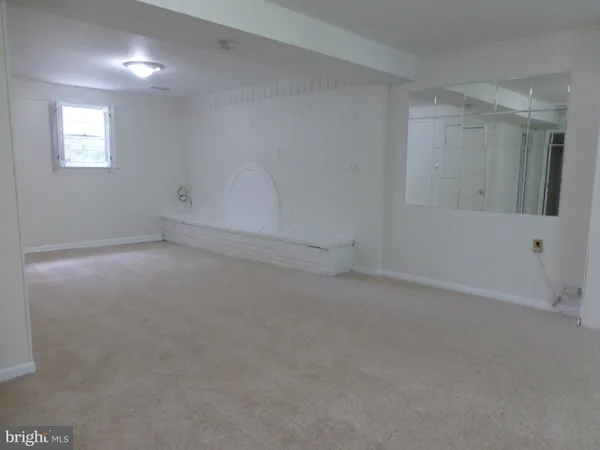 a view of an empty room and fire place