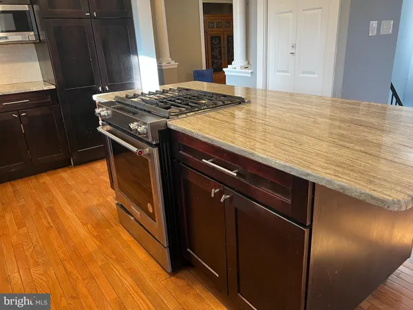 a view of a room with wooden floor and a window