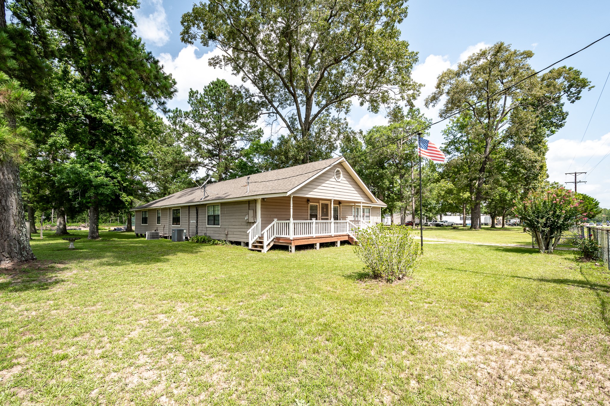 10994 Fostoria Road Cleveland, TX 77328 - Photo 5 of 13 a yellow house in middle of the forest