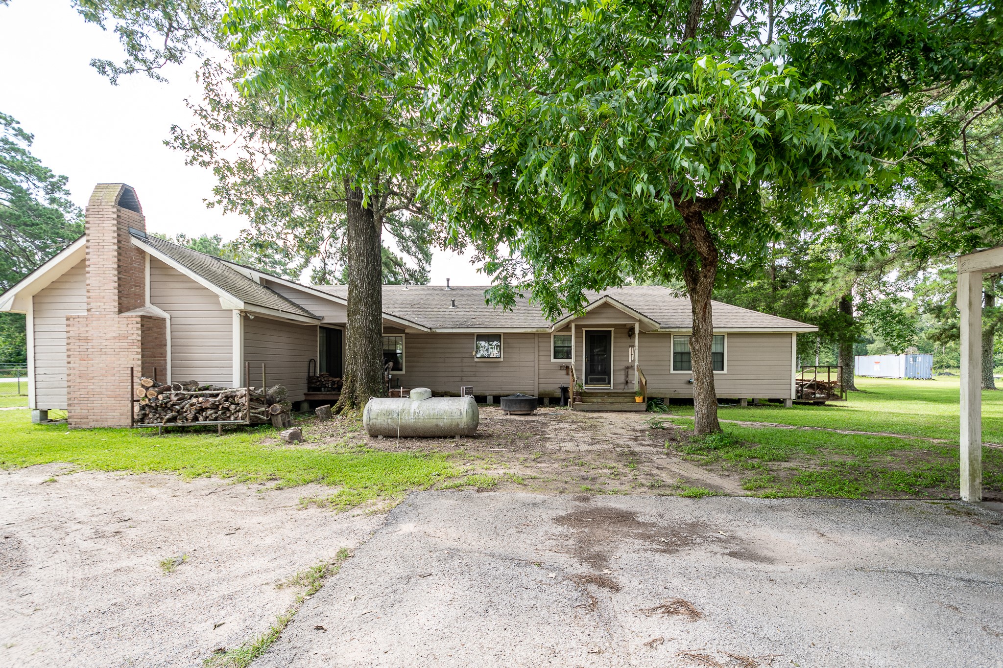 10994 Fostoria Road Cleveland, TX 77328 - Photo 10 of 13 a front view of a house with a yard and trees
