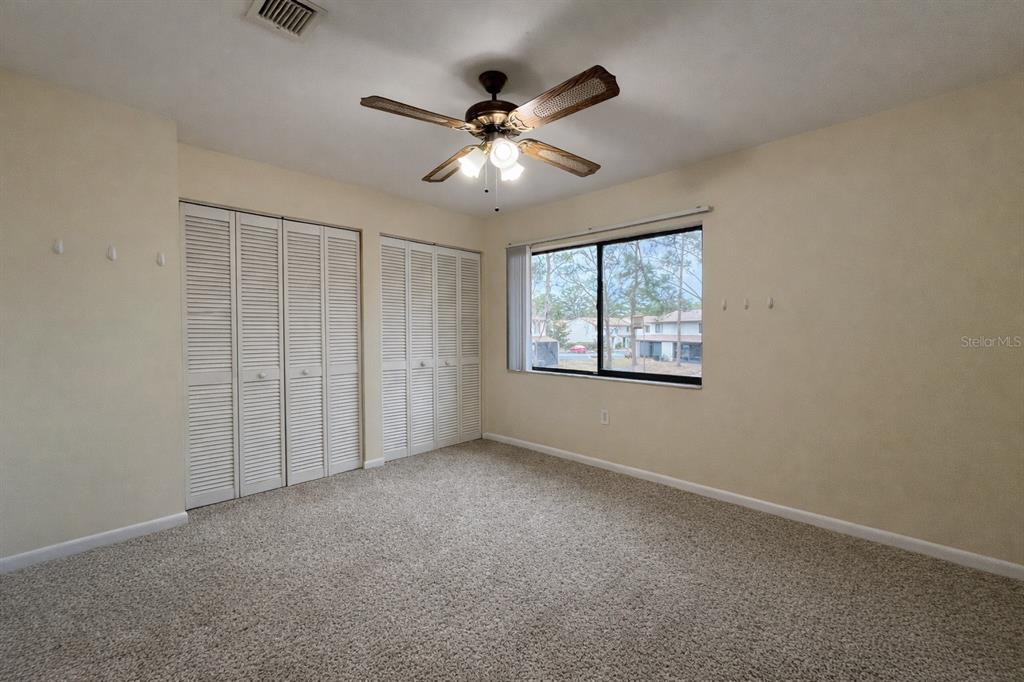 2635 Southwest 35th Place, Unit 604 Gainesville, FL 32608 - Photo 12 of 28 an empty room with windows and fan