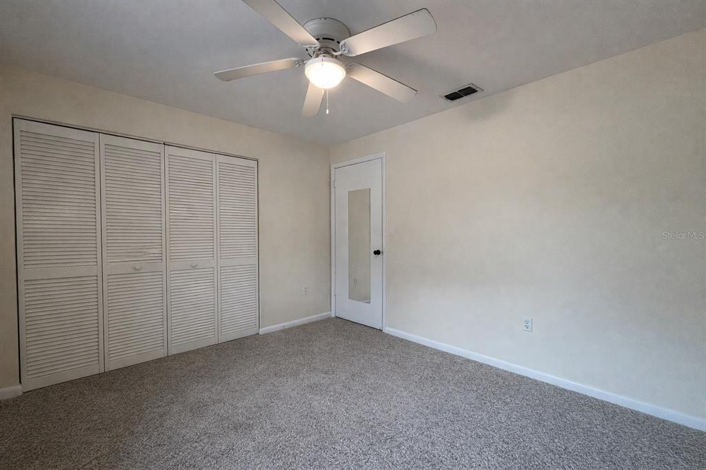 2635 Southwest 35th Place, Unit 604 Gainesville, FL 32608 - Photo 17 of 28 an empty room with a ceiling fan and a fan