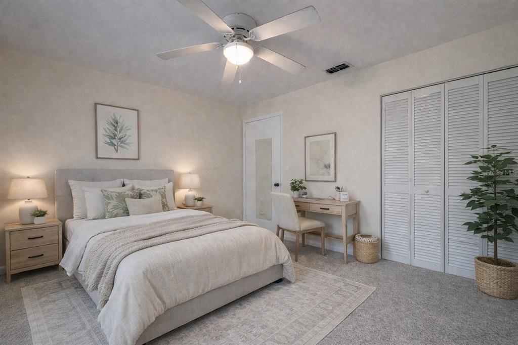 2635 Southwest 35th Place, Unit 604 Gainesville, FL 32608 - Photo 18 of 28 a bedroom with a large bed and a chandelier