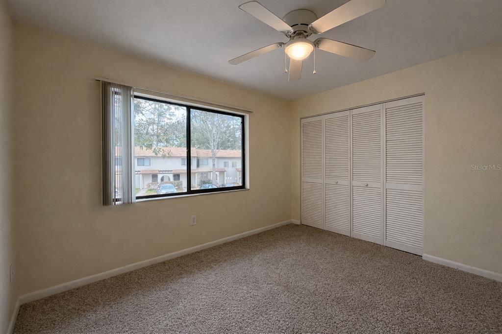 2635 Southwest 35th Place, Unit 604 Gainesville, FL 32608 - Photo 19 of 28 an empty room with windows and fan