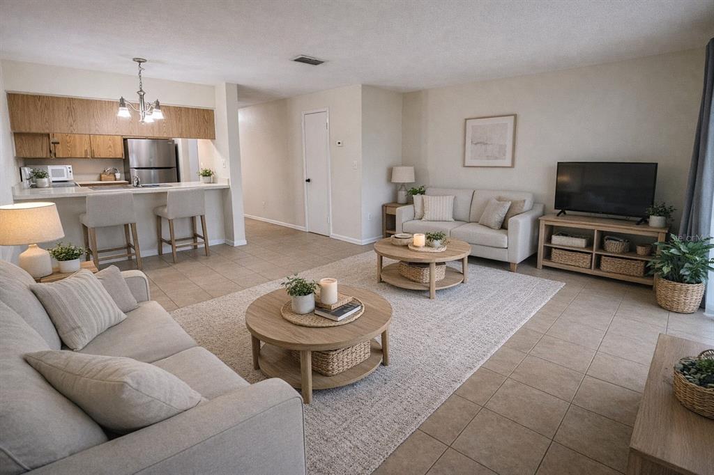 2635 Southwest 35th Place, Unit 604 Gainesville, FL 32608 - Photo 2 of 28 a living room with furniture and a flat screen tv