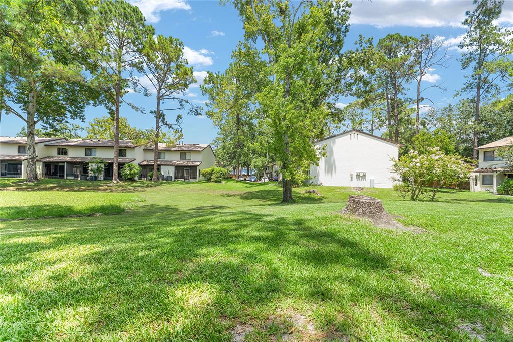 2635 Southwest 35th Place, Unit 604 Gainesville, FL 32608 - Photo 28 of 28 a view of a house with a big yard and large trees