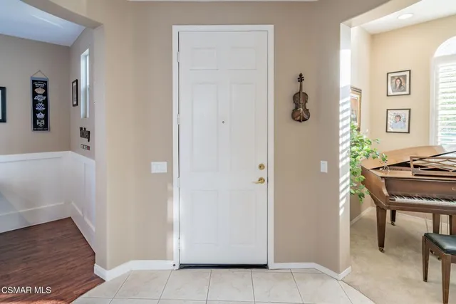 a living room with furniture windows and a flat screen tv