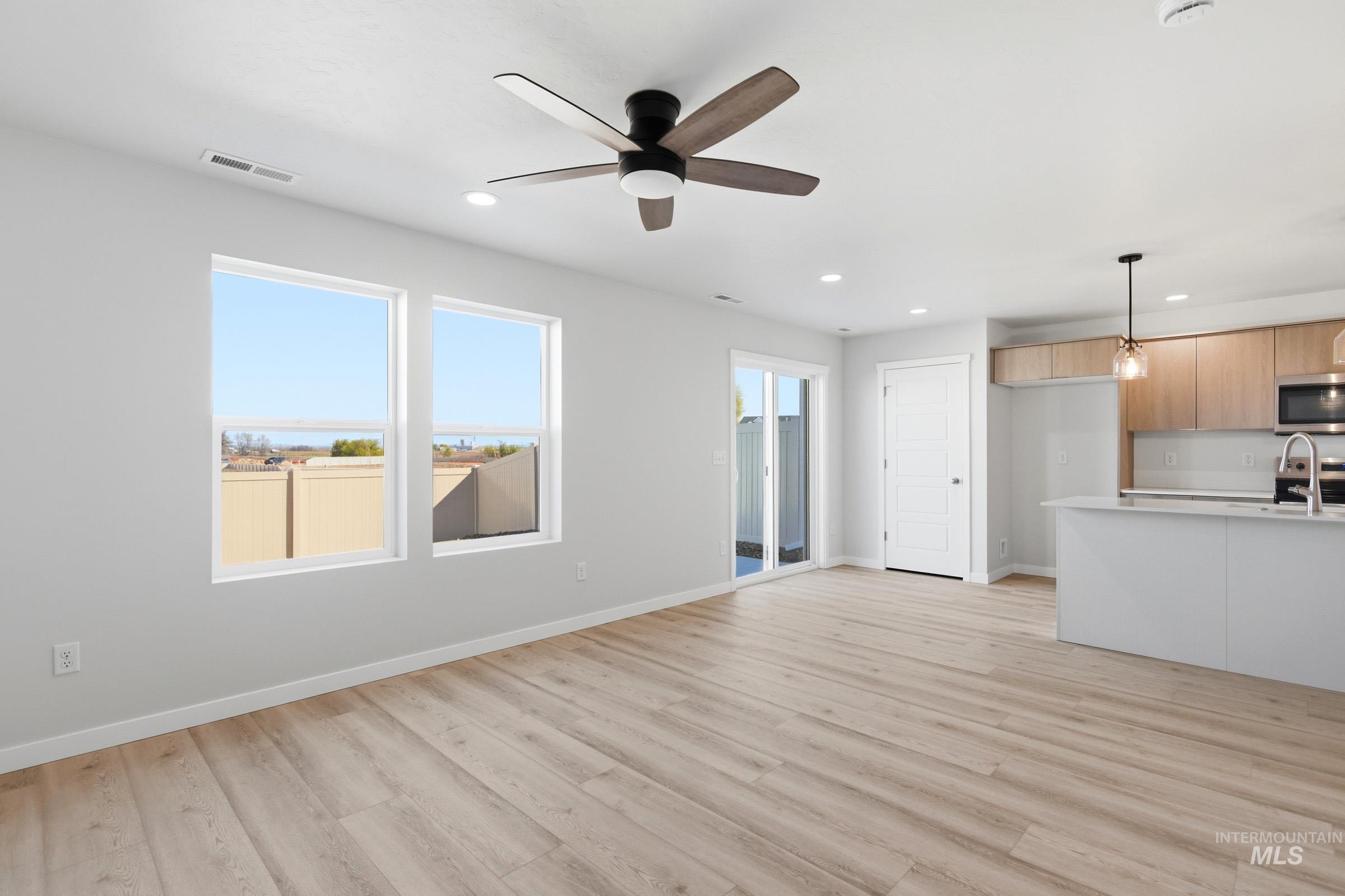 10800 Rutland Street Caldwell, ID 83605 - Photo 11 of 21 Open-concept living area with light wood-finish flooring, recessed lighting, and a contemporary ceiling fan