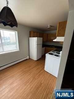 340 Hudson Street, Unit 26 Hackensack, NJ 07601 - Photo 3 of 7 a kitchen with a wooden floor and a stove