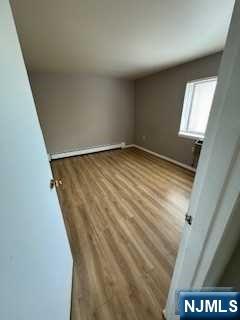 340 Hudson Street, Unit 26 Hackensack, NJ 07601 - Photo 7 of 7 a view of empty room with window and stairs