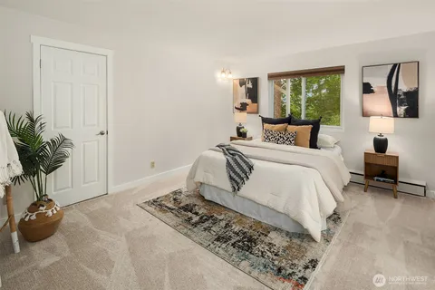 a bedroom with a bed and a potted plant
