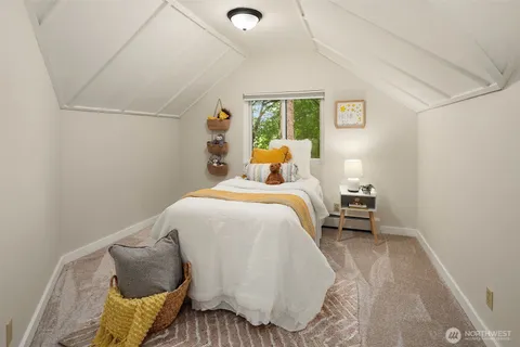 a bed room with a bed and a chair