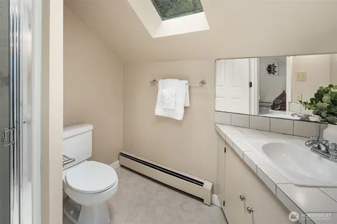 a bathroom with a sink toilet and a mirror