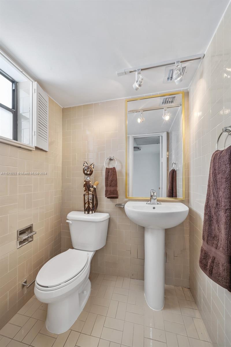 100 Ocean Ln Drive, Unit PH2 Key Biscayne, FL 33149 - Photo 12 of 15 a bathroom with a toilet sink and mirror