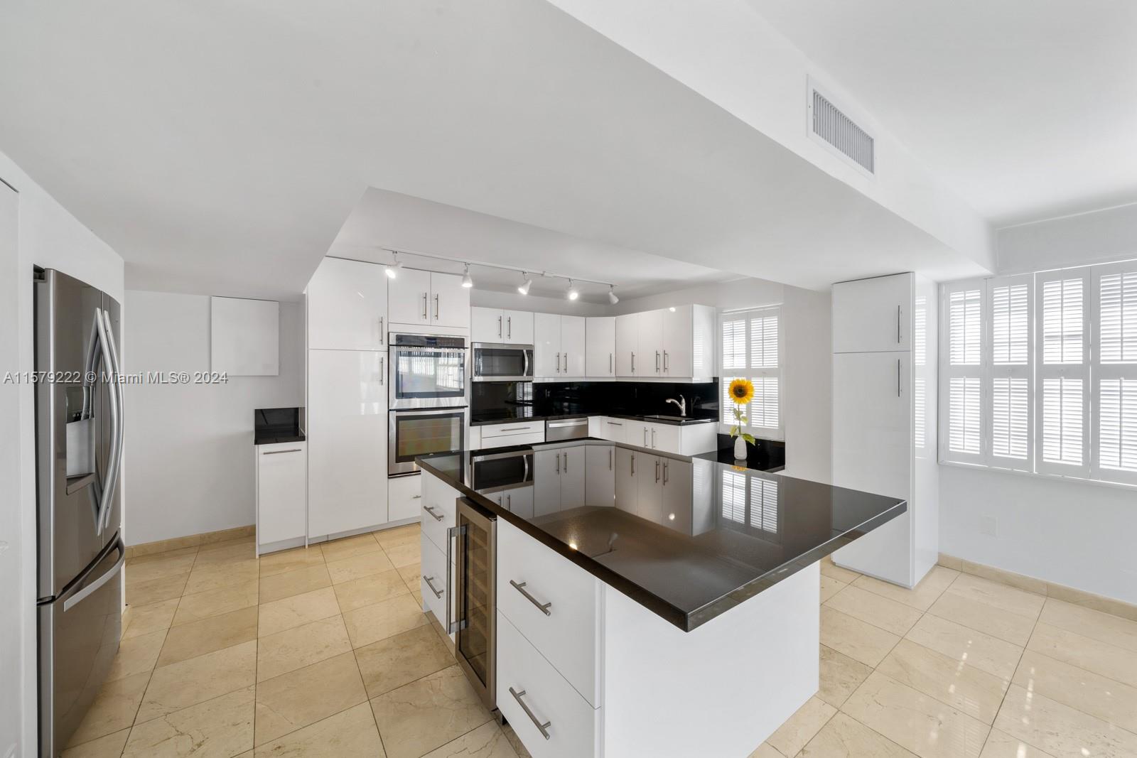 100 Ocean Ln Drive, Unit PH2 Key Biscayne, FL 33149 - Photo 6 of 15 a kitchen with stainless steel appliances granite countertop a sink a refrigerator and a stove