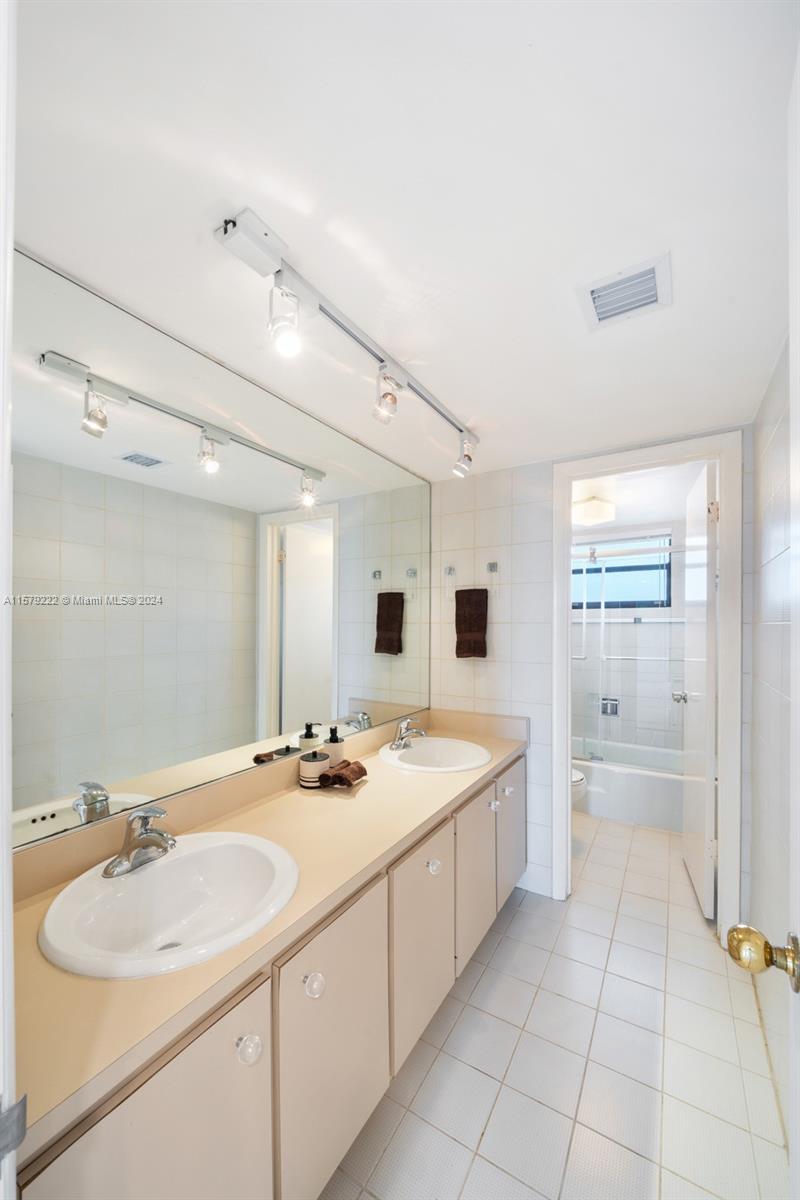 100 Ocean Ln Drive, Unit PH2 Key Biscayne, FL 33149 - Photo 10 of 15 a bathroom with a sink double vanity granite tub shower and a mirror