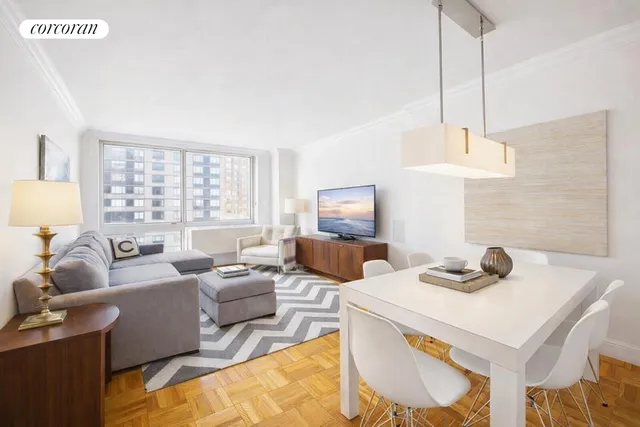 a living room with furniture a window and a lamp