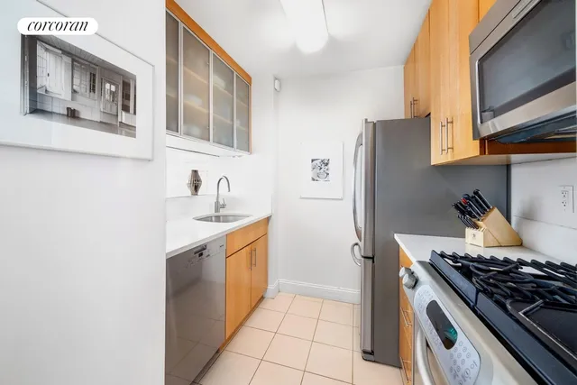 a kitchen with stainless steel appliances granite countertop a stove and a refrigerator