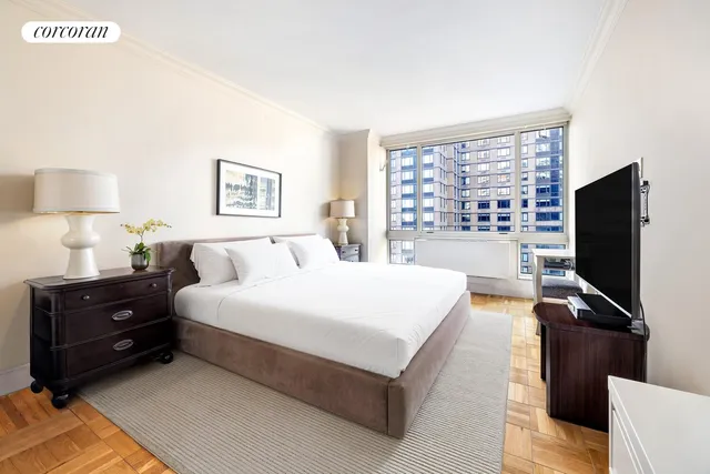 a bedroom with a bed and a flat screen tv