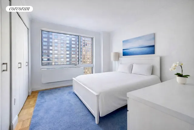 a bedroom with bed and a night stand