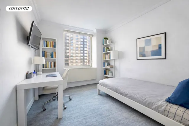 a bedroom with a bed and a table in it