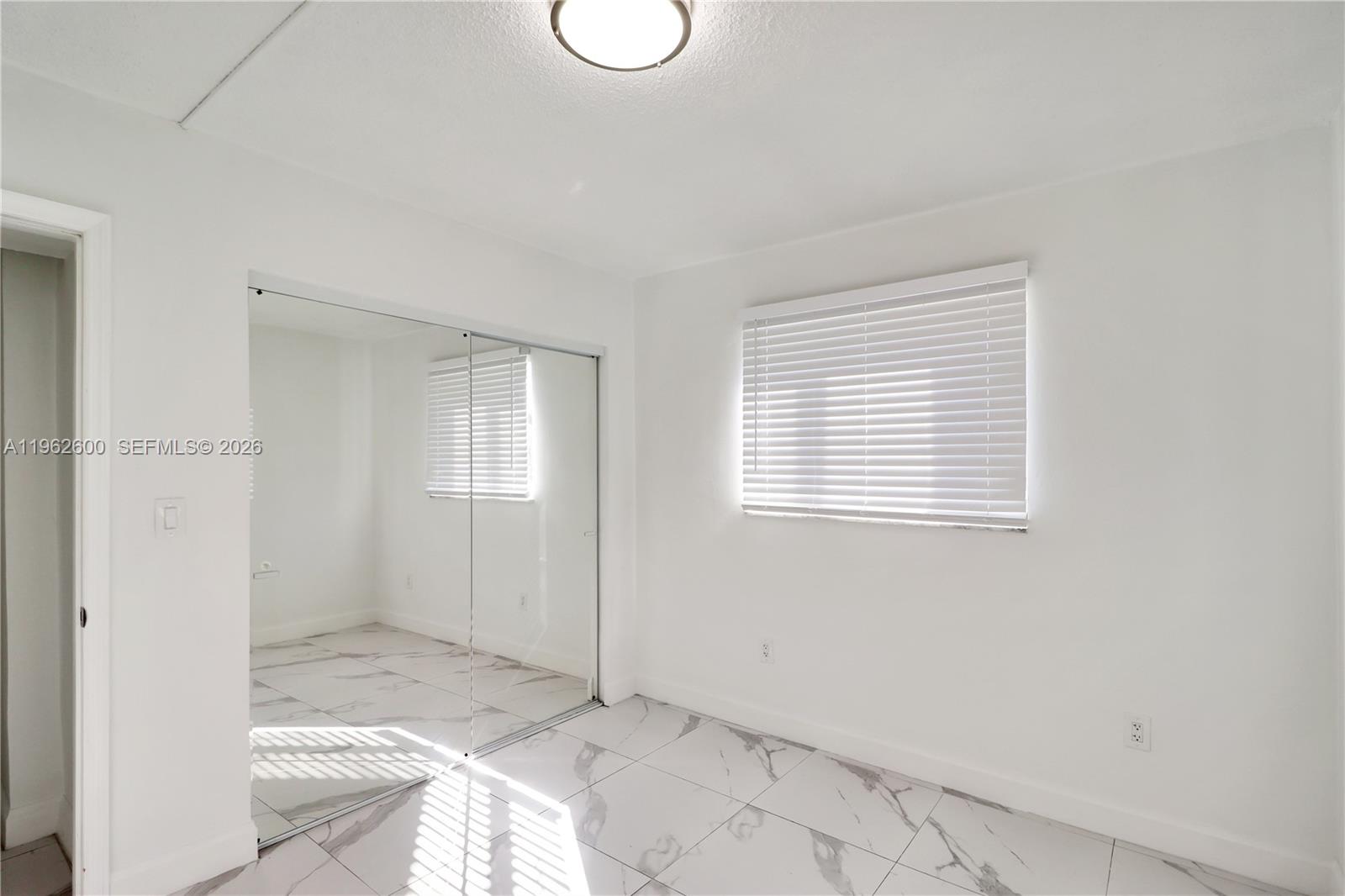 3601 Southwest 2nd Street, Unit 3601 Miami, FL 33135 - Photo 12 of 19 a view of a livingroom with wooden floor and a window