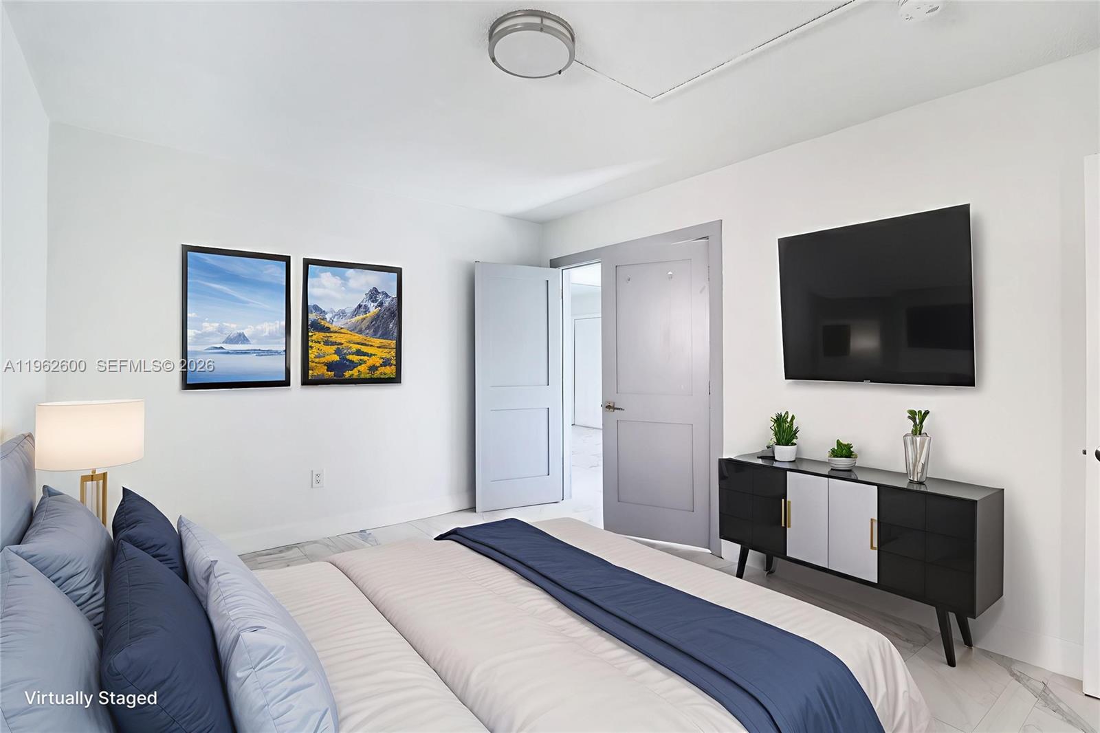 3601 Southwest 2nd Street, Unit 3601 Miami, FL 33135 - Photo 13 of 19 a bedroom with a bed and a flat screen tv