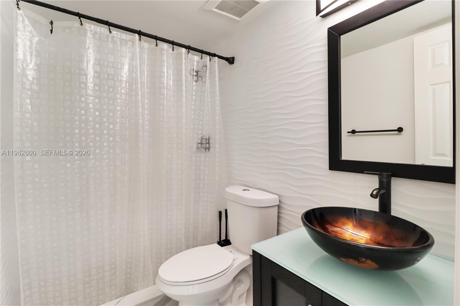 3601 Southwest 2nd Street, Unit 3601 Miami, FL 33135 - Photo 15 of 19 a bathroom with a toilet and a sink