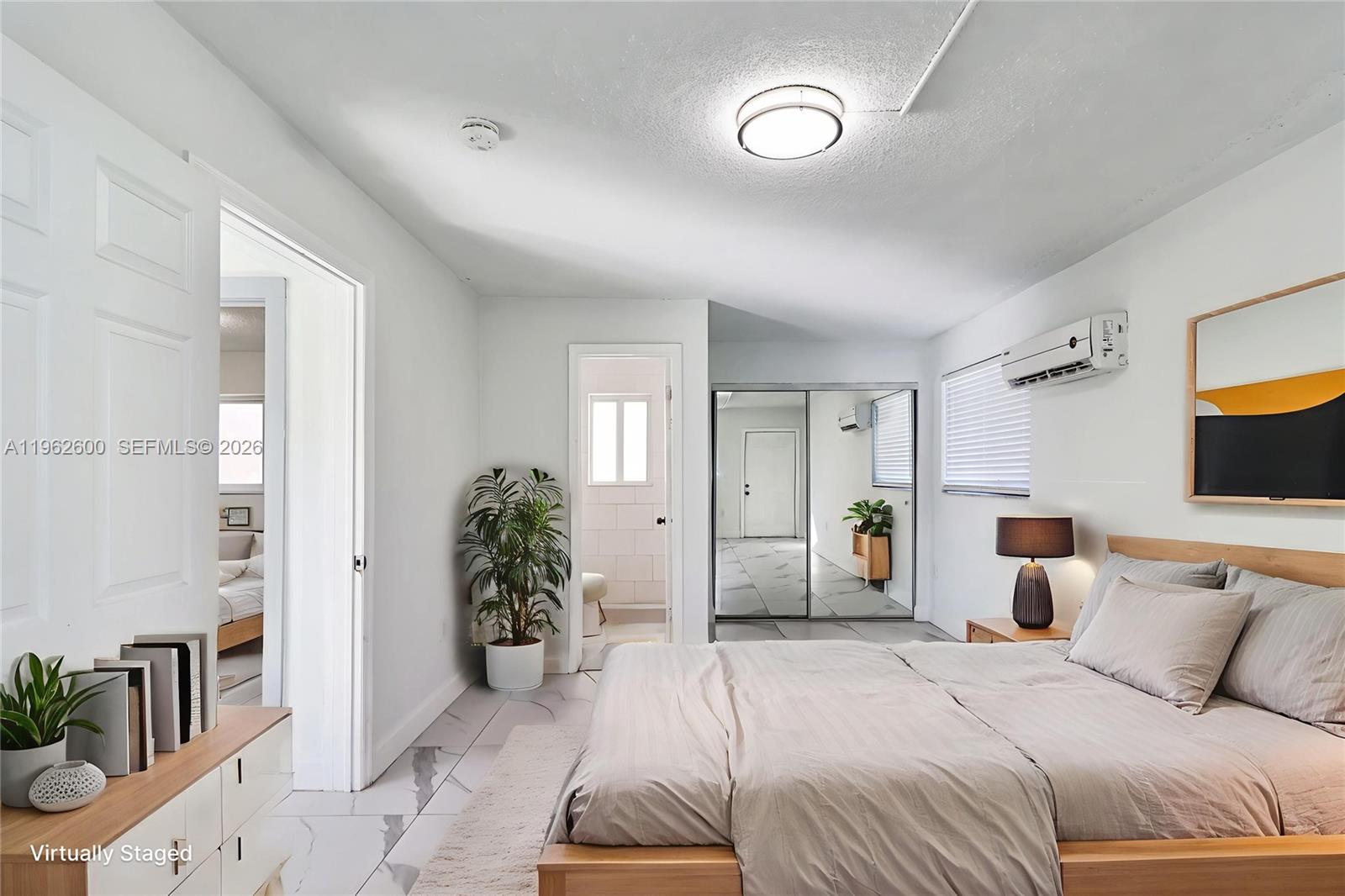 3601 Southwest 2nd Street, Unit 3601 Miami, FL 33135 - Photo 6 of 19 a bedroom with a large bed and a chandelier