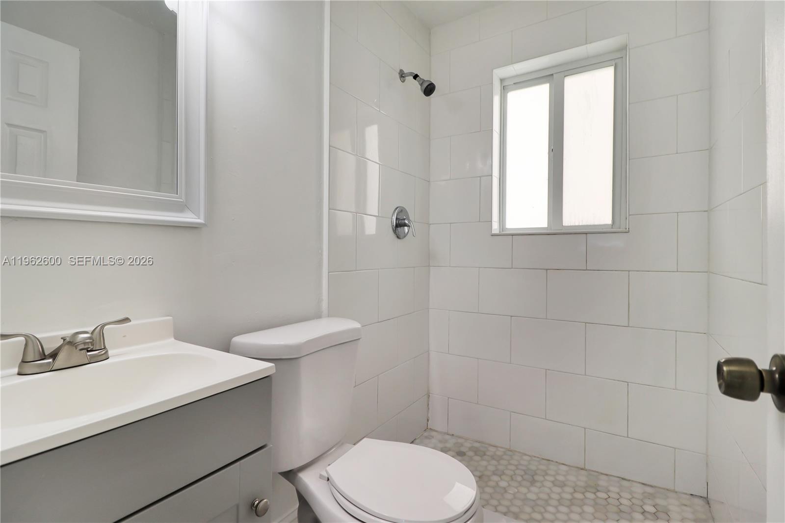 3601 Southwest 2nd Street, Unit 3601 Miami, FL 33135 - Photo 8 of 19 a bathroom with a sink toilet and shower