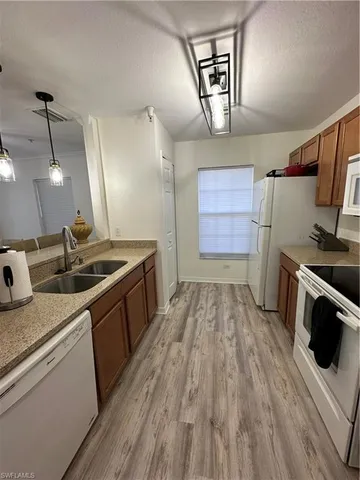 a kitchen that has a sink and a stove in it