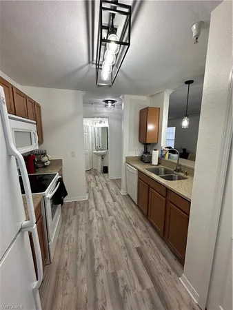 a large kitchen with a wooden floor and cabinets