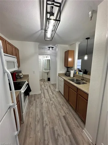 a large kitchen with a wooden floor and cabinets
