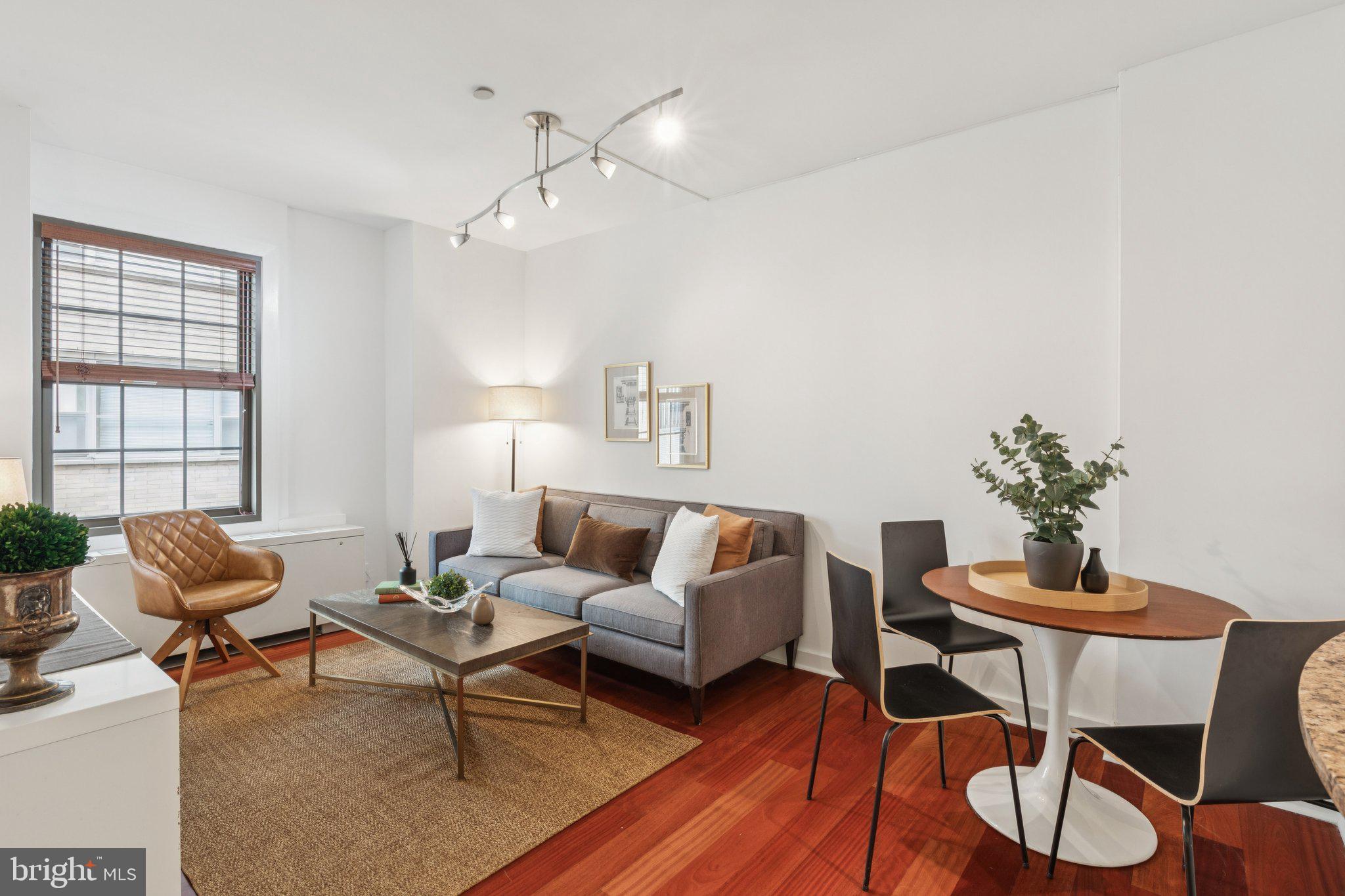 a living room with furniture and wooden floor