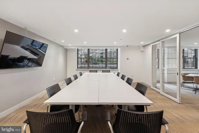 a dinning room with furniture and wooden floor